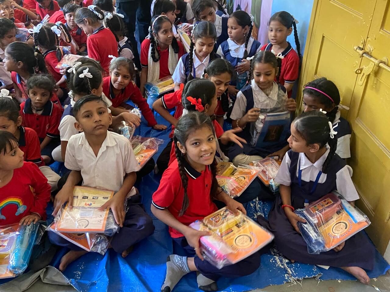 Children receiving free education kits from Shree Sneh Foundation