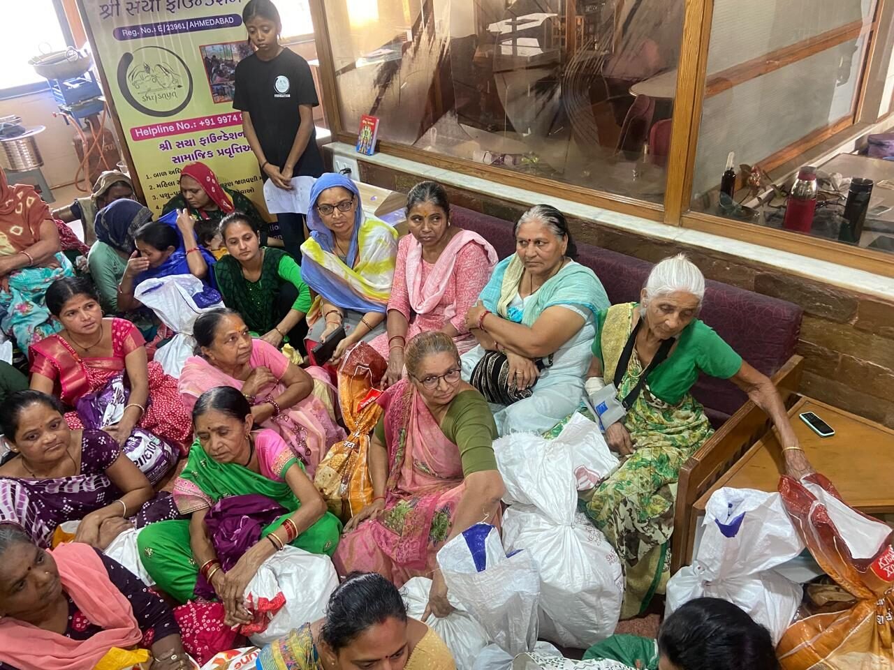 Elderly women receiving grocery kits from Shree Sneh Foundation