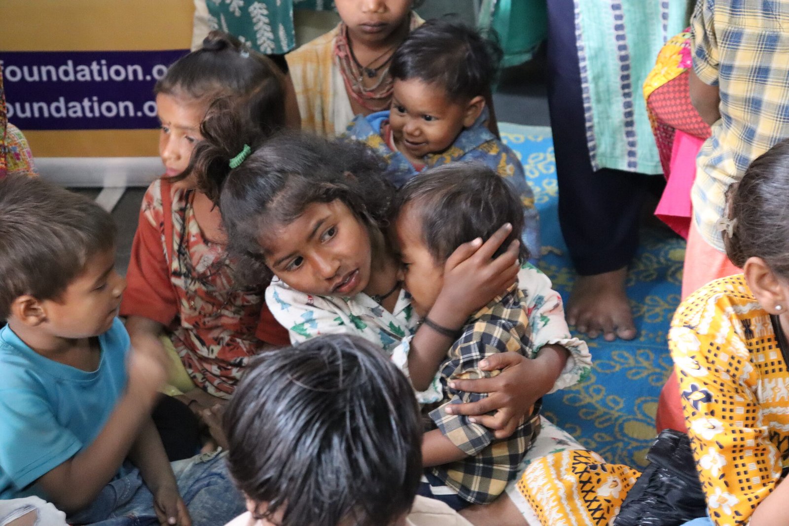 A young girl caring for a toddler at Shree Sneh Foundation shelter